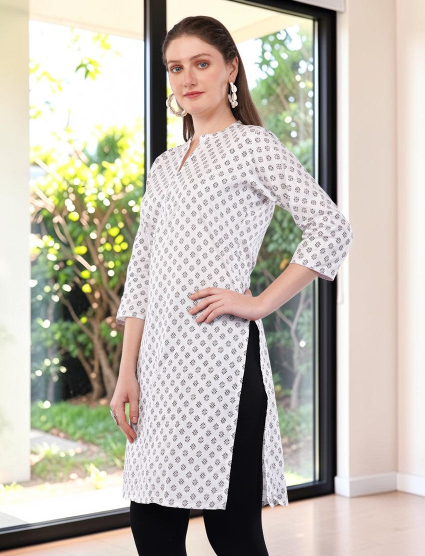 Eelika white cotton kurti with black geometric print, mandarin collar, and 3/4 sleeves worn by a model