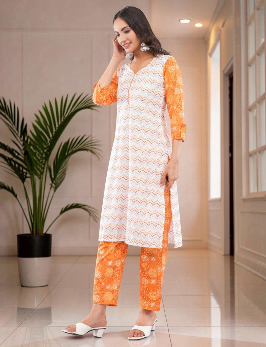 Eelika women's white and orange cotton salwar suit set with geometric print, V-neck, and 3/4th sleeves