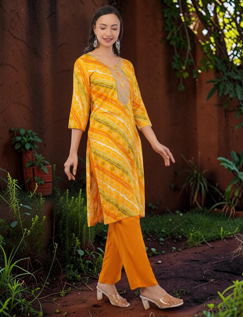Eelika yellow and orange cotton Bandhani print salwar suit with embroidered round neck and 3/4 sleeves on a model