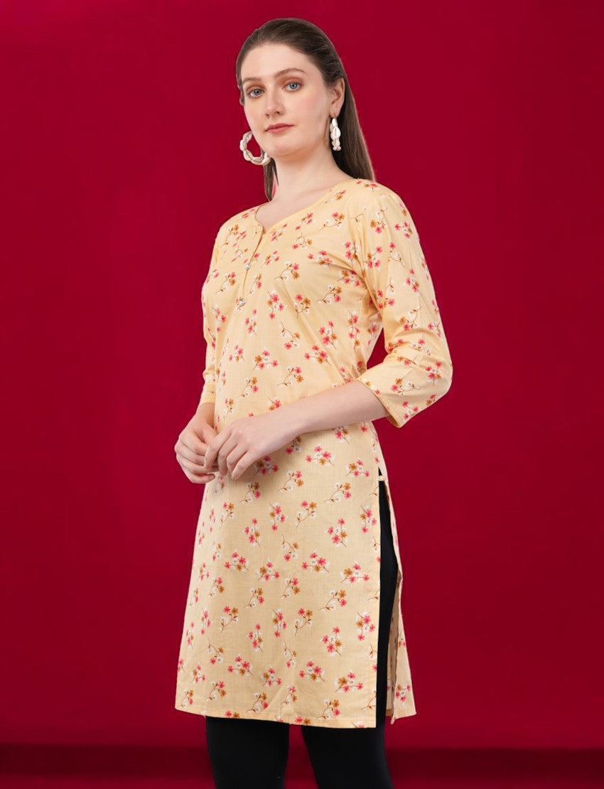 Eelika women's yellow cotton kurti with floral print, round neck, and 3/4 sleeves, worn by a model.